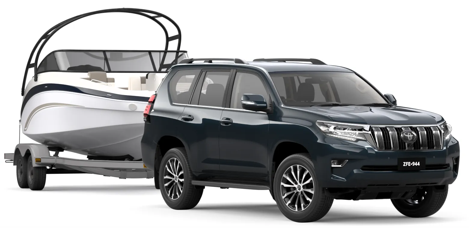 A dark blue Toyota LandCruiser Prado towing a boat on a tandem trailer