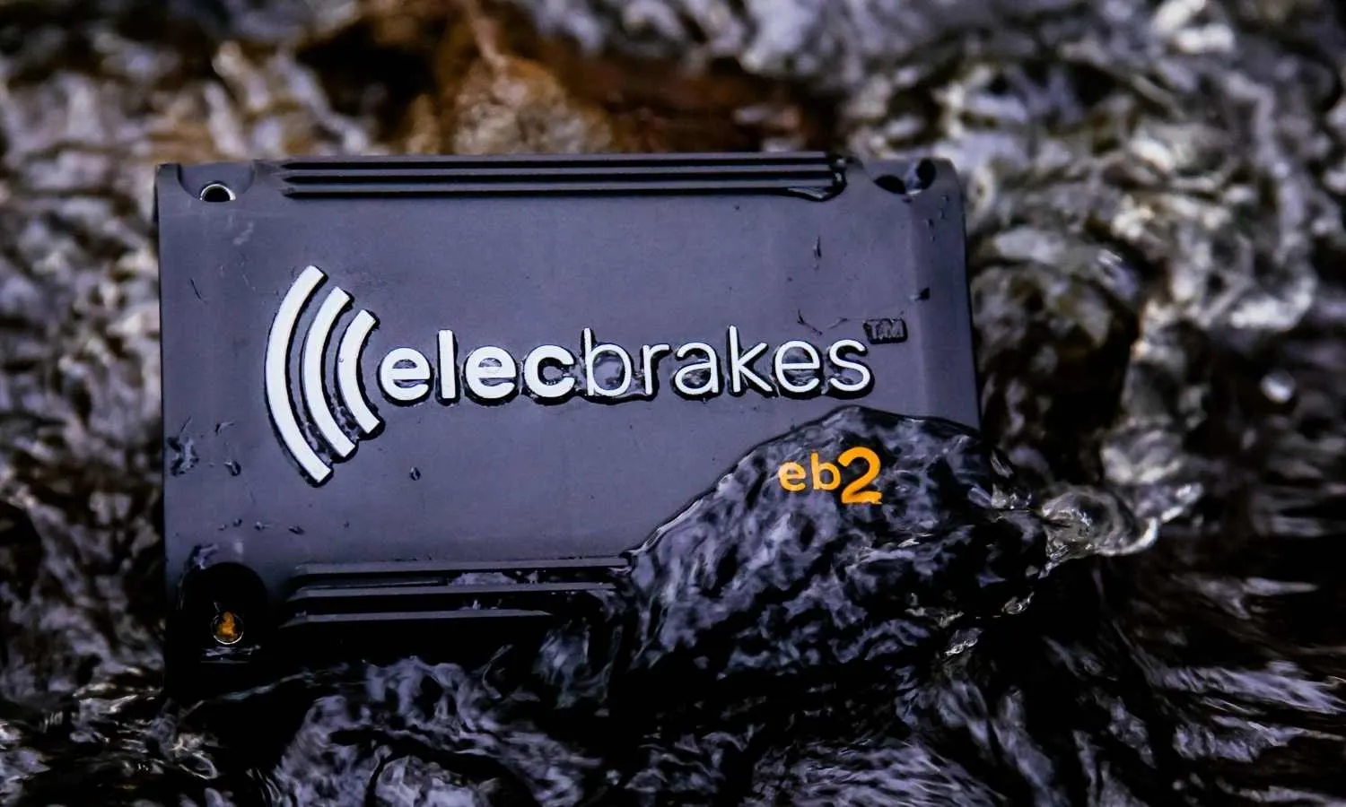 Elecbrakes EB2 unit partially submerged in water demonstrating waterproof durability