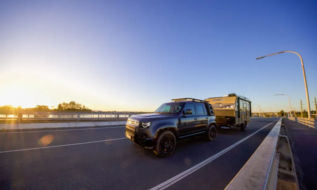Caravan being towed along a rural Australian highway during Easter road trip