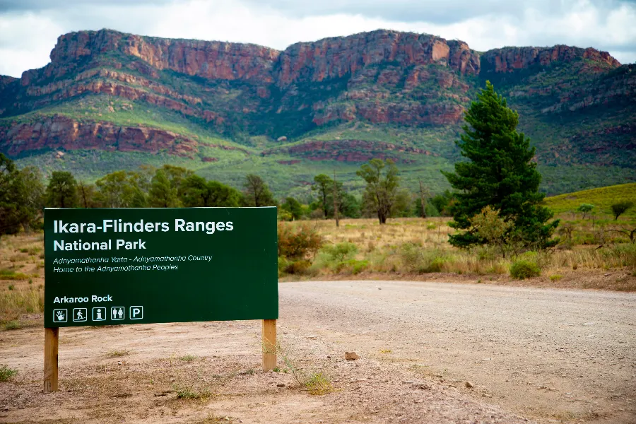 Ikara-Flinders Ranges National Park sign with mountains in background.