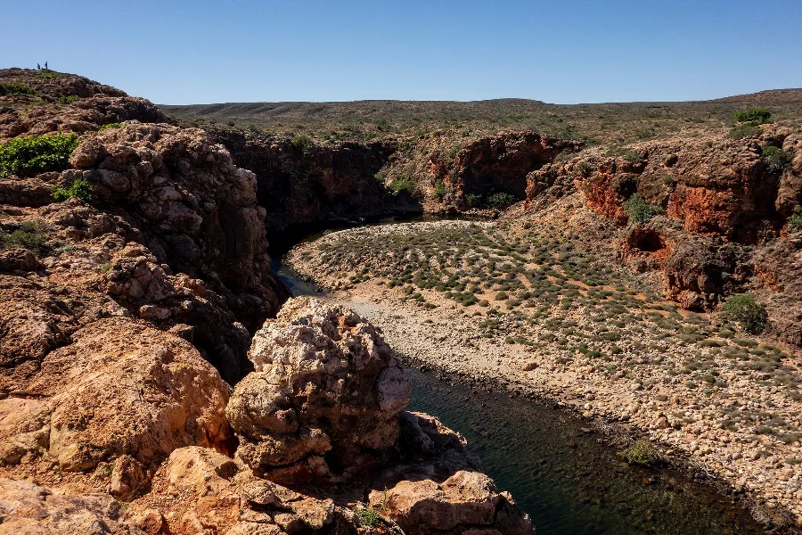 Rocky gorge with a river flowing through it.