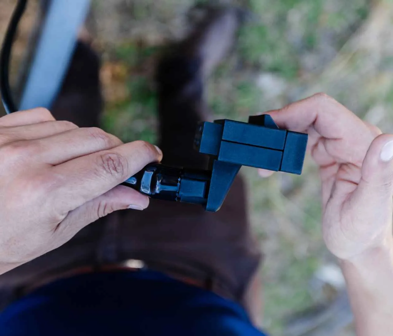 Two hands joining an Elecbrakes plug and play adaptor to a trailer plug