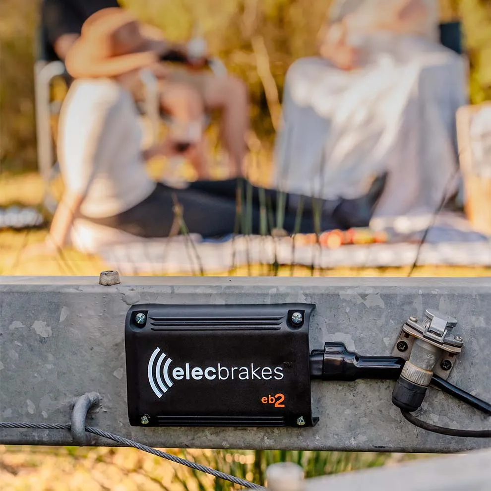 An Elecbrakes EB2 mounted on a trailer drawbar with campers relaxing behind it